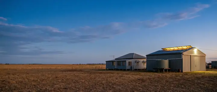 Rural homestead and shed with rooftop solar at dusk